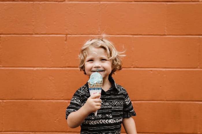 A little kid eating an ice-cream, whose parent has one rule about the food the kid eats