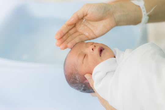 A mother bathing her baby