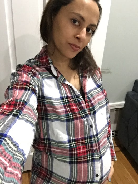 Yasmine Singh posing in a flannel button up shirt