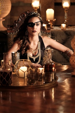 The Magicians Summer Bishil as Margo sitting behind table