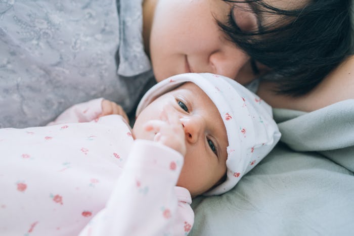A mom laying with her newborn talking about consent