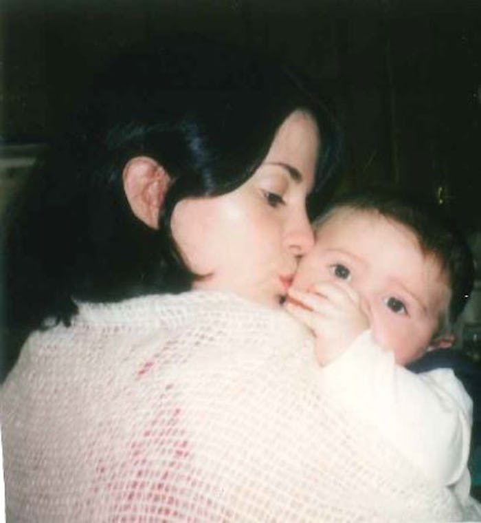 A woman kissing her child on the cheek 