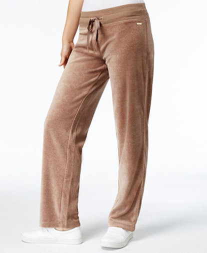 A female model posing in brown velour joggers