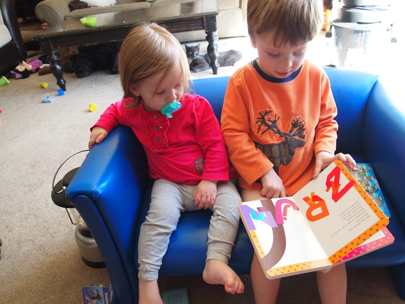 Gemma Hartley’s two kids reading a children’s illustrated book.