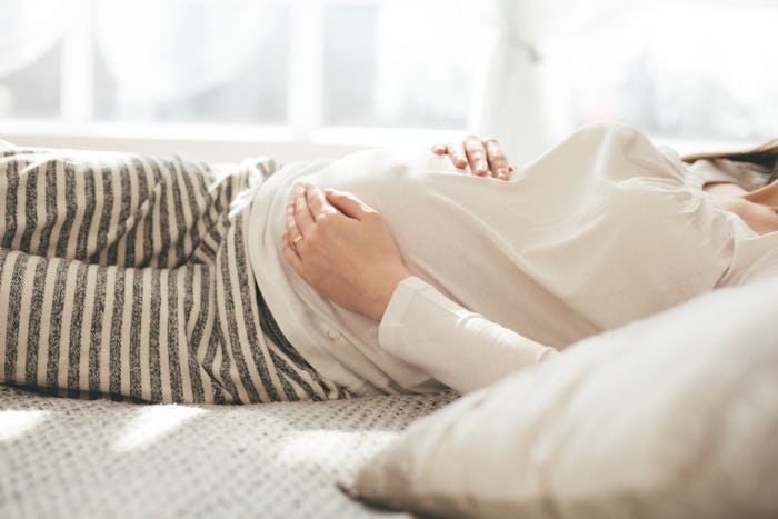 Experts say getting out of bed while pregnant may require some maneuvering.