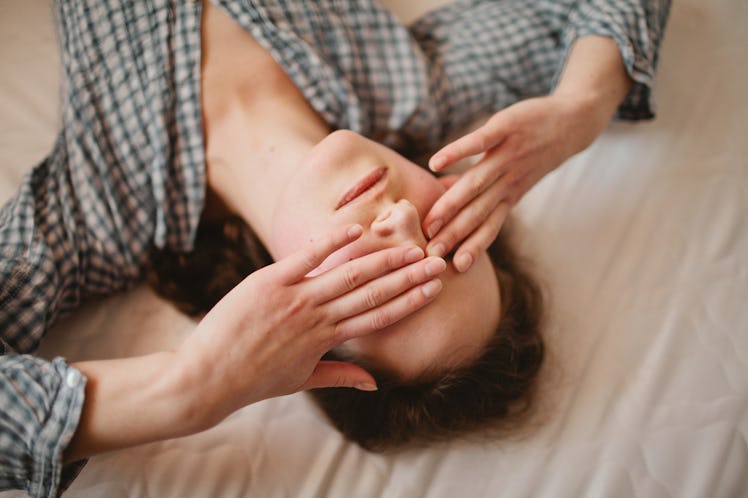 A man lying on floor and rubbing his eyes after getting a flu shot