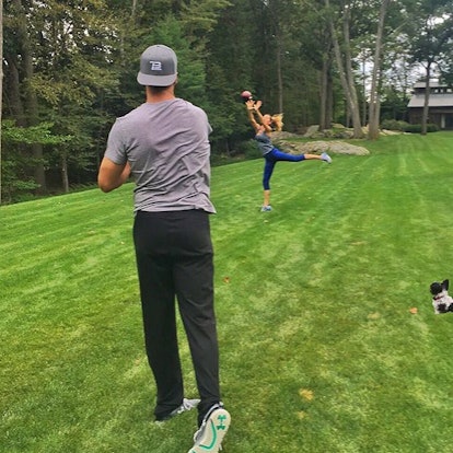 Tom Brady enjoying his days with his wife, Gisele, playing football in their back yard while serving...