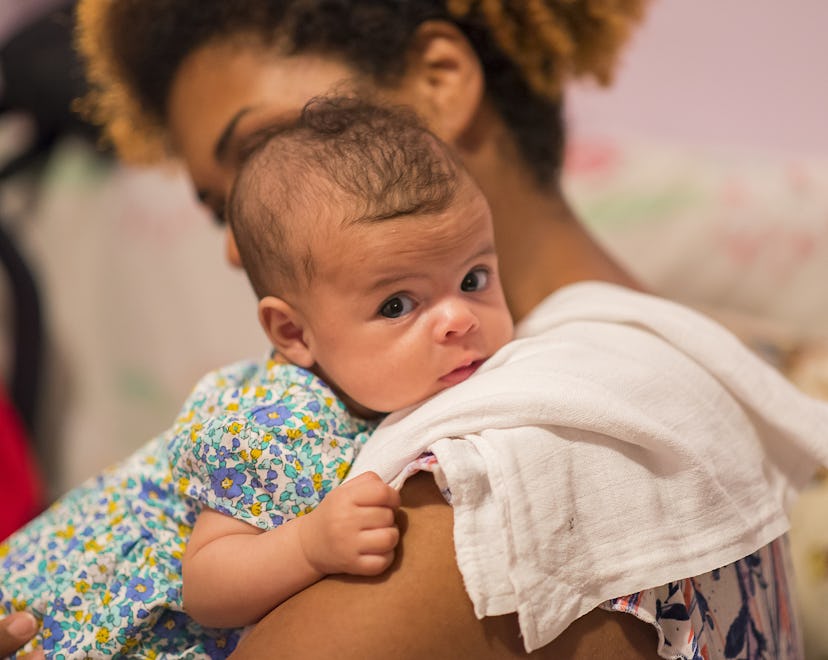 a sweet newborn being burped in an article about can you burp a baby too hard?