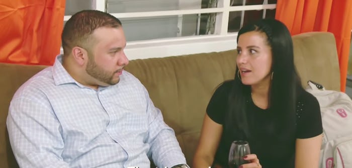 Ricky & Ximena from 90 Day Fiance sitting on a couch talking