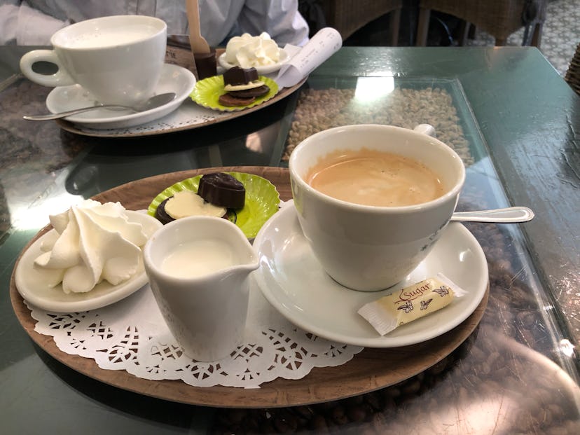 Coffee, milk, and sweets served on a tray
