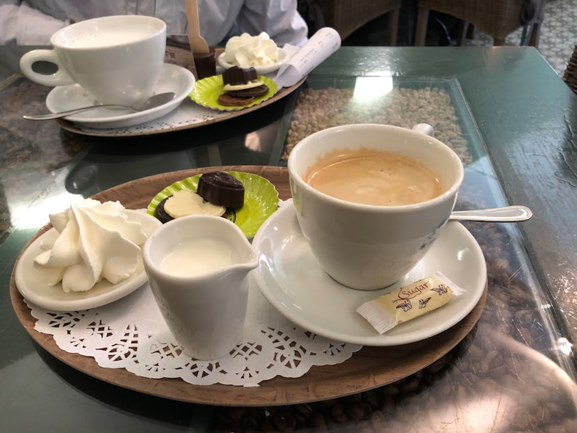 Coffee, milk, and sweets served on a tray