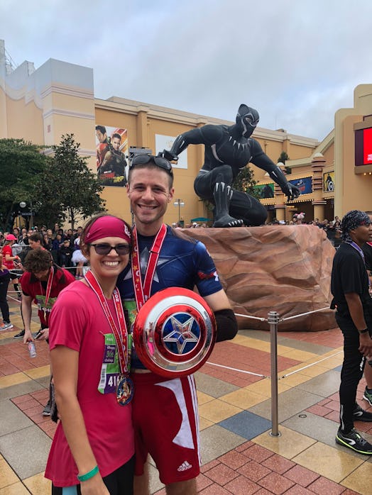 Couple posing for a photo while the man is holding a Captain America shield