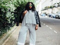 Plus-Size Influencer posing for a picture in matching two set with black leather jacket. 