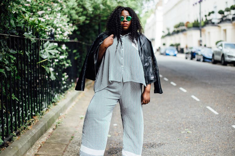 Plus-Size Influencer posing for a picture in matching two set with black leather jacket.