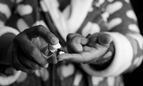 A woman pouring a dermatologist-recommended skin care cream on her finger
