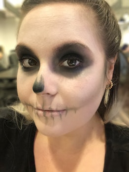 Elite Daily Senior Style Editor Theresa Massony models an easy skull makeup look for Halloween
