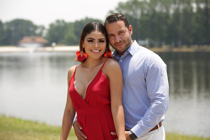 Jonathan and Fernanda from 90 Day Fiance smiling for a photo with a lake in the background