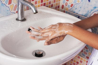 A girl washing her chapped hands