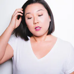 A brunette woman looking downwards