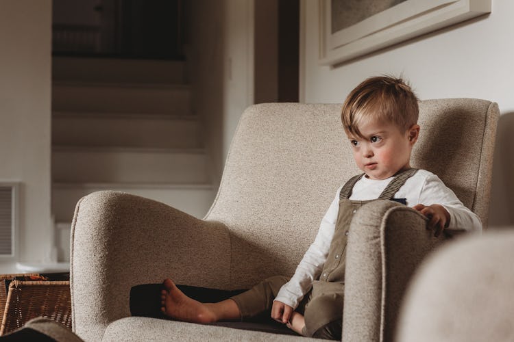 Enrica's son sitting on an armchair
