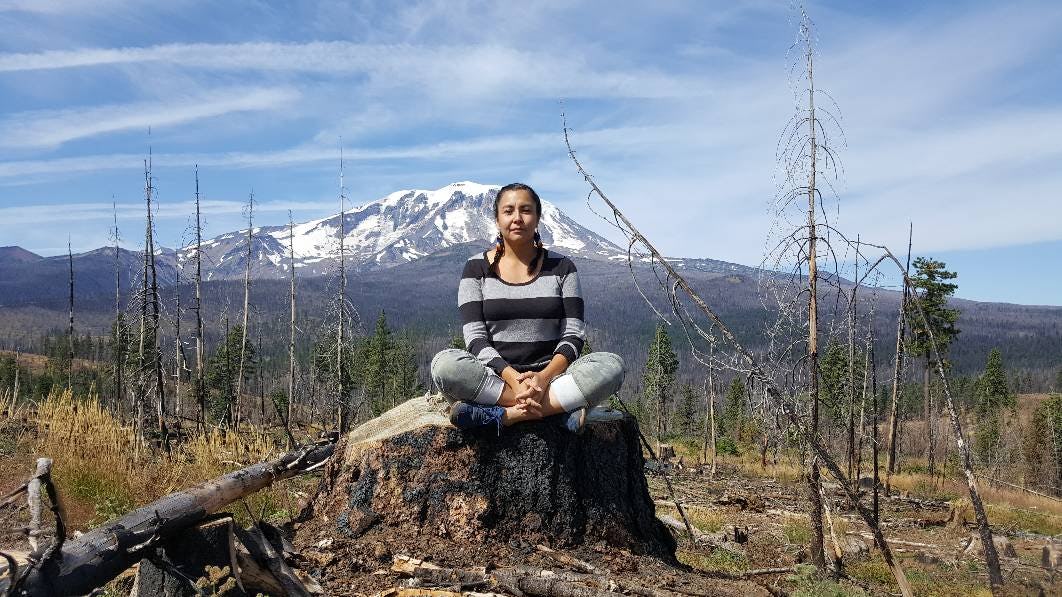 Christine Nobiss enjoying her day in the nature on Thanksgiving sitting on a stone