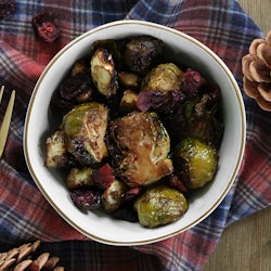 Honey-balsamic Brussels sprouts served in a bowl with a fork