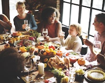 a family seated around a thanksgiving table