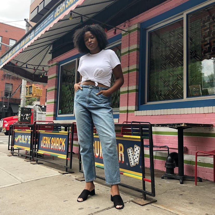 Blogger and model Imani Randolph wears her baggy, anti-skinny jeans with a tied-up white tee and som...