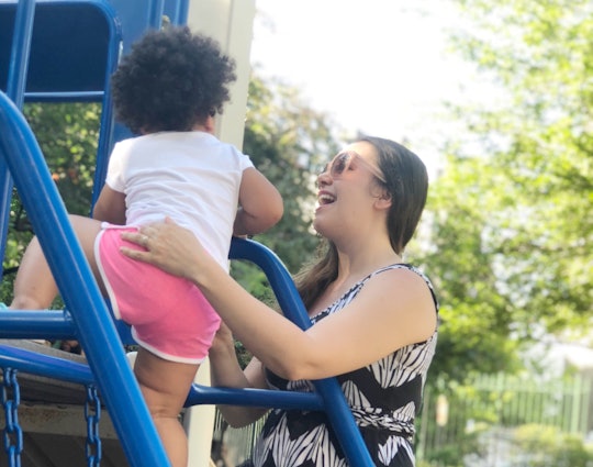 A mom with high-functioning anxiety playing with her daughter on a playground