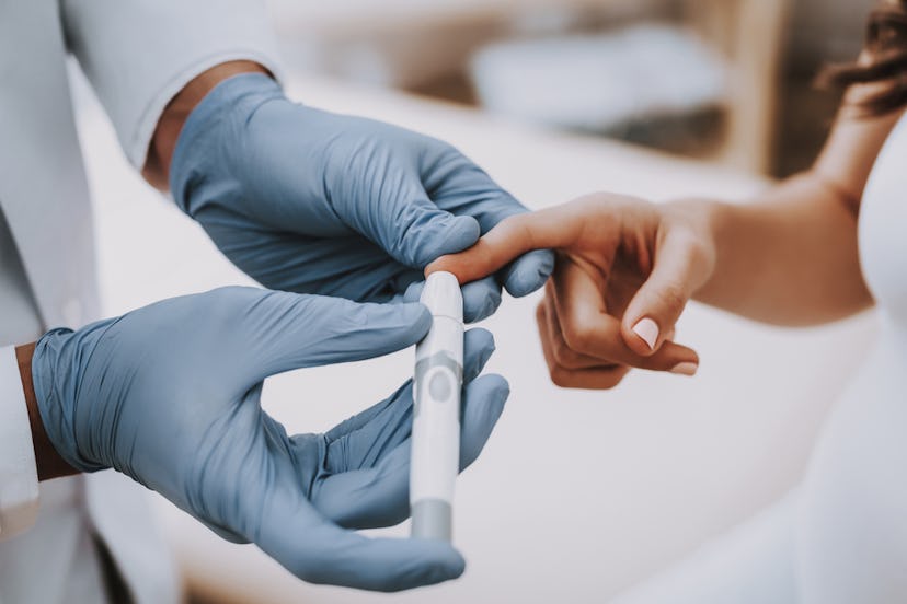 Woman testing blood sugar level