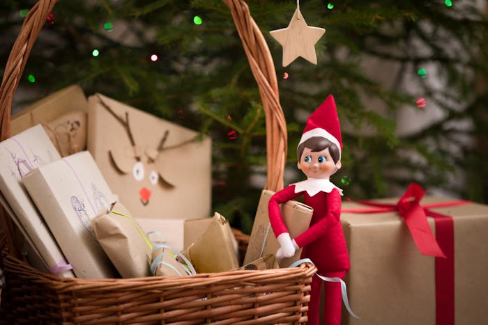 an Elf on the Shelf doll with a basket of packages