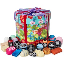 A Lush gift set with a large gift box and Lush's bath bombs and shower gels.