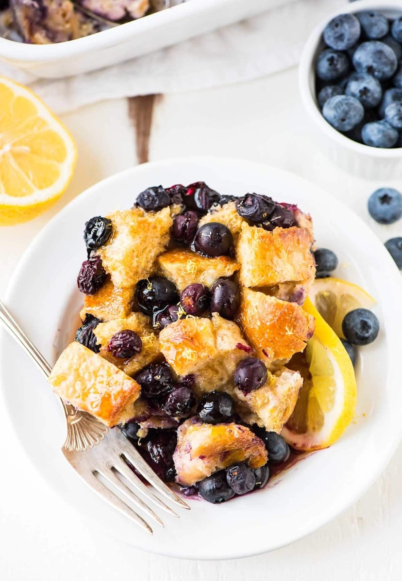 plate full of french toast covered in blueberries 