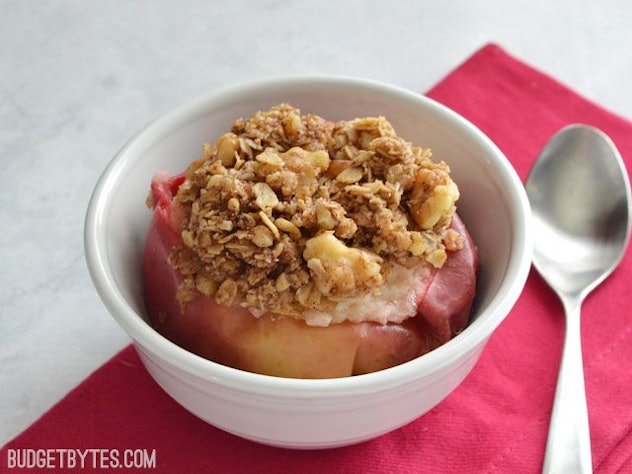 bowl of a cooked apple with a crumble inside