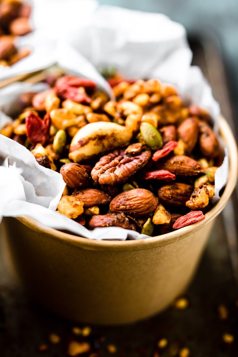 close up of bowl full of walnuts, almonds and other nuts