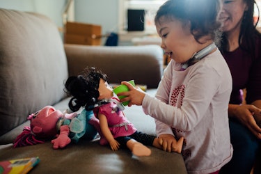 Xiomara playing with her dolls