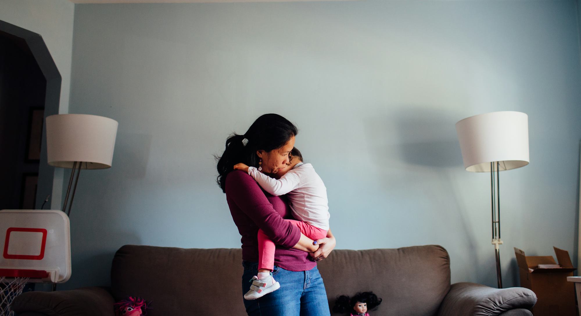 A model holding her medically fragile child an carrying it