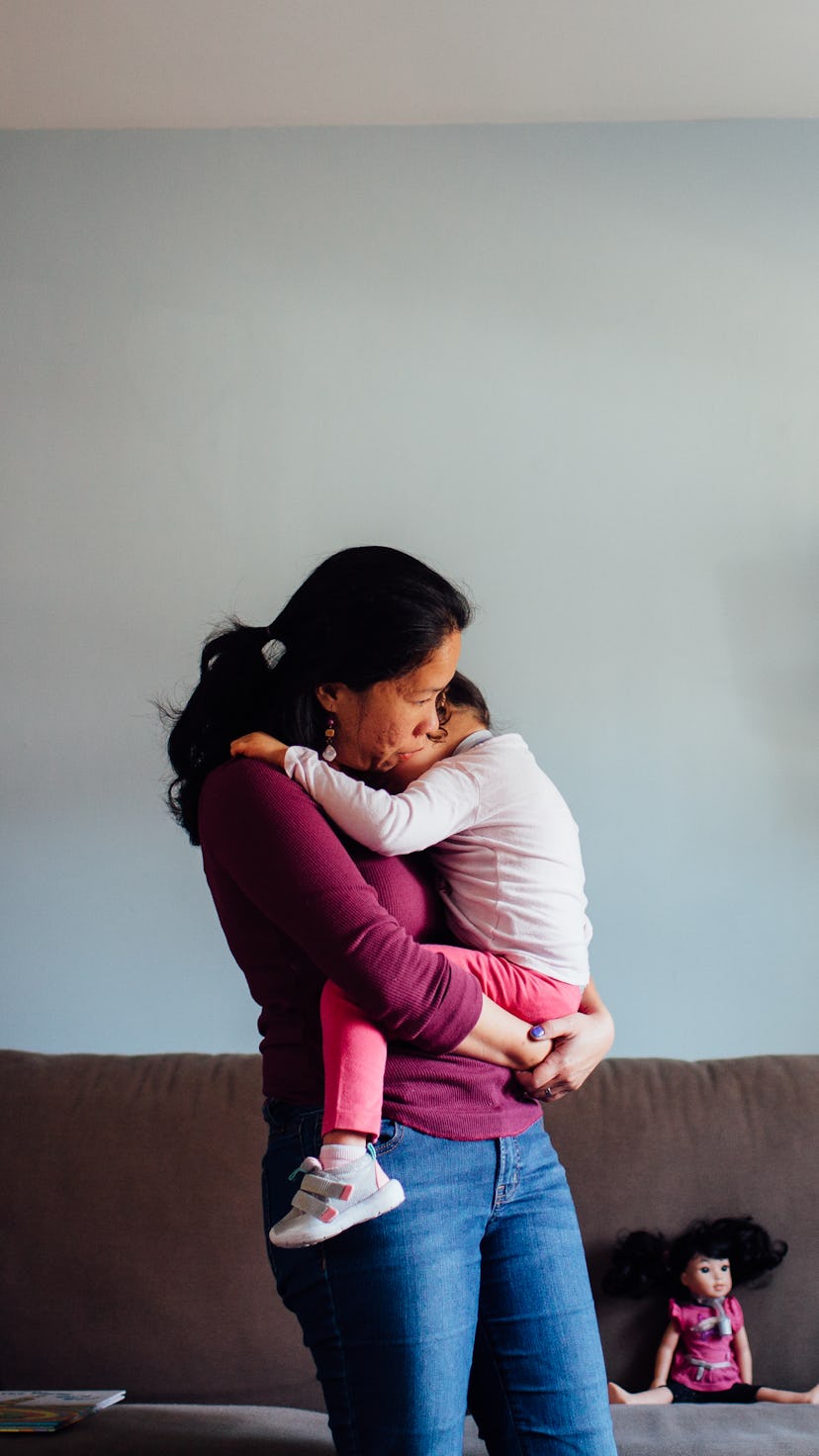 A model holding her medically fragile child an carrying it