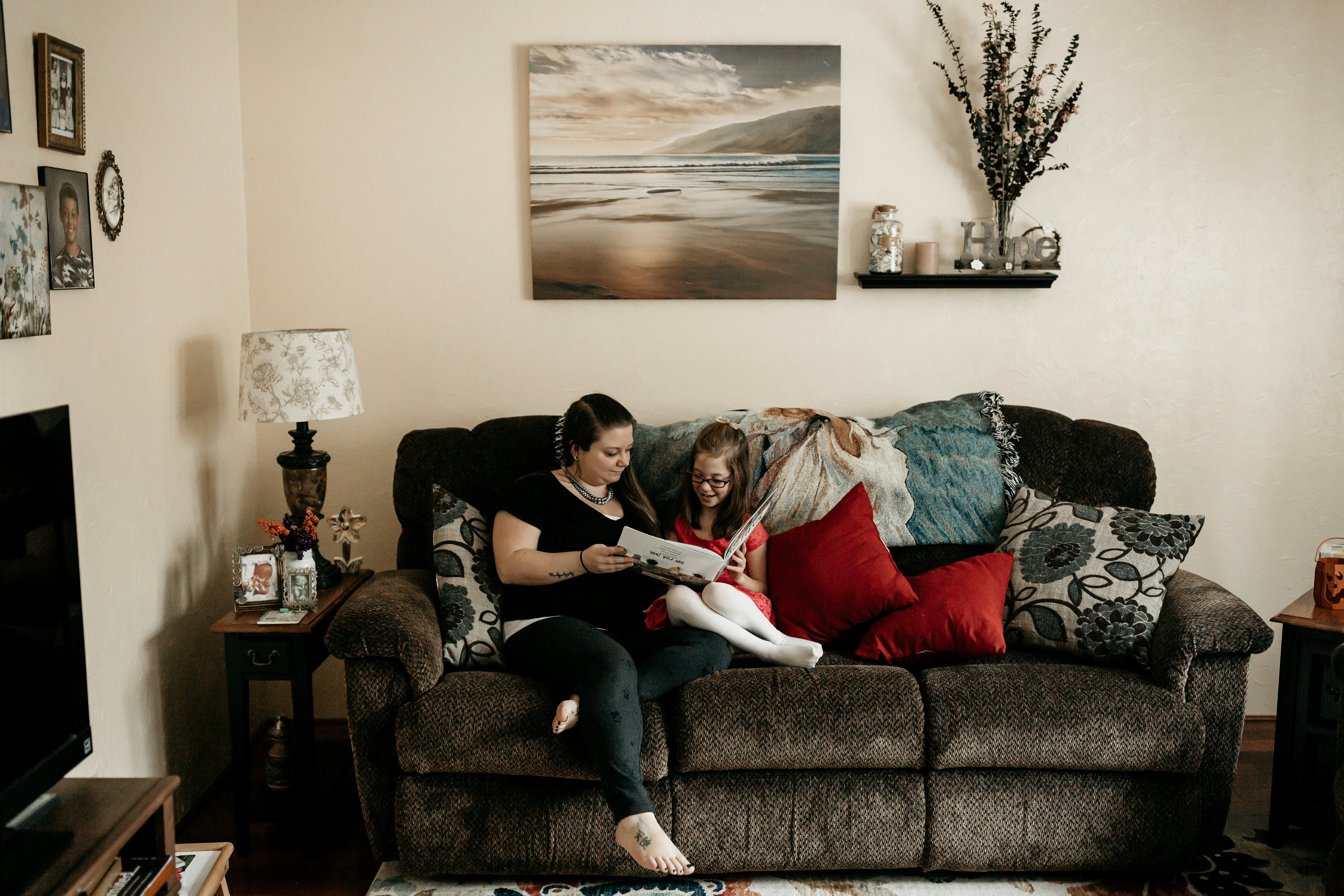 A mother reading a book with her daughter