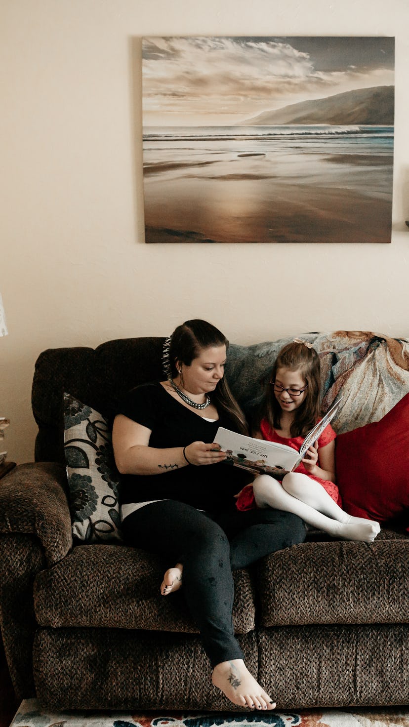 A mother reading a book with her daughter