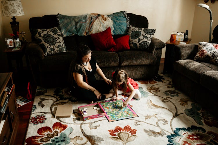 A mother playing a board game with her daughter