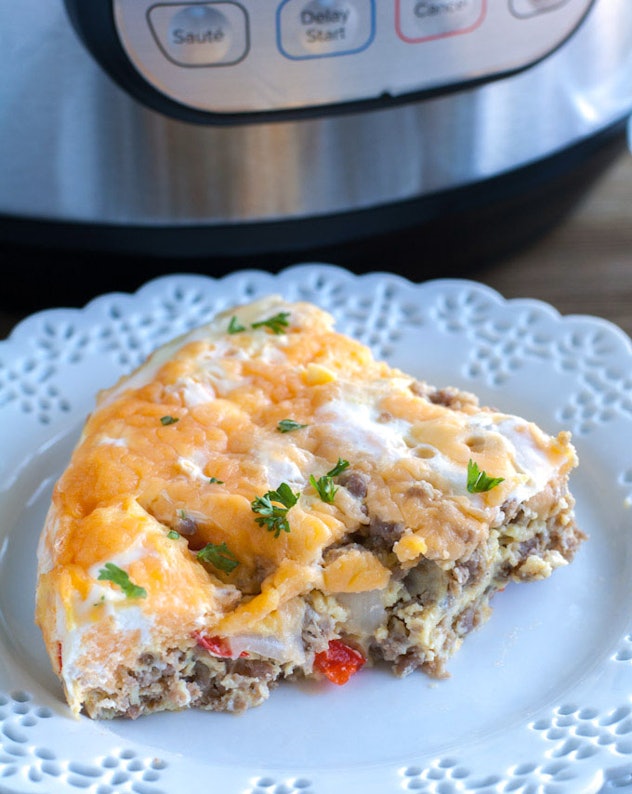 slice of egg casserole with meat, cheese, onion, and peppers inside