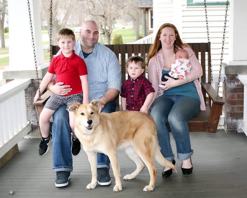 Kelly Kraus Mencke posing for a picture with her Husband, their three children and their dog