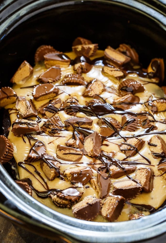 Thanksgiving Desserts: A crockpot full of melted peanut butter with cut up Reese's on top drizzled i...