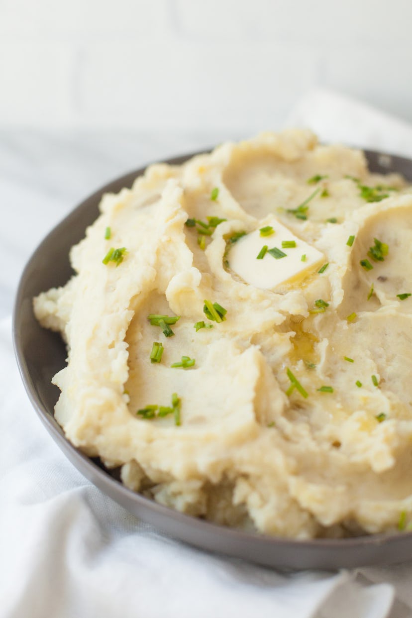 mashed potatoes on a plate garnished with green parsley