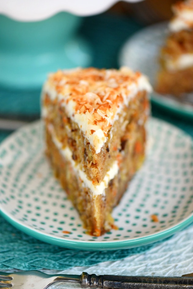 Thanksgiving Desserts: A carrot cake with a layer of white frosting in middle and on top of cake spr...