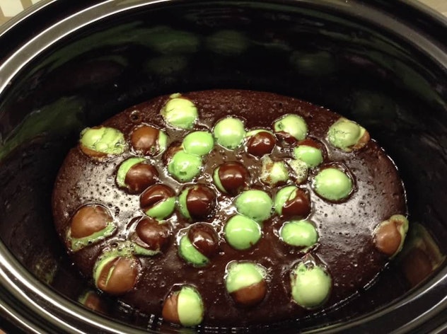 Thanksgiving Desserts: A crockpot of brown cake with mint green and brown balls randomly placed on t...