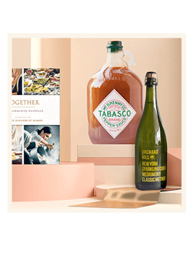 Tabasco pepper sauce next to an Orchard Hill green champagne bottle 