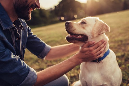 man holding his dog.