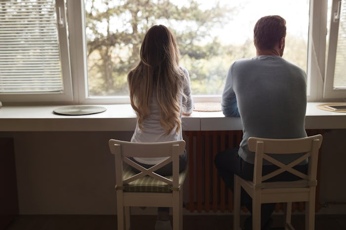 Man and woman sitting in chairs, facing away from camera